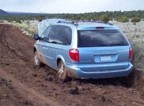 A vehicle is stuck in the thick mud of County Road 42