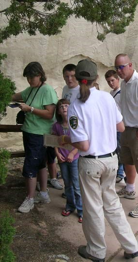 Image of a volunteer talking with visitors on the trail Image of a volunteer talking with visitors on the trail
