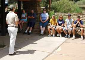 A Student Conservation Association Intern orients a school group to El Morro. A Student Conservation Association Intern orients a school group to El Morro.