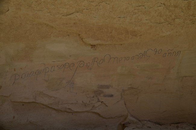 Archaic Spanish inscription on a rock face.