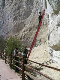 Image of park rangers monitoring a crack in Inscription Rock. Image of park rangers monitoring a crack in Inscription Rock.