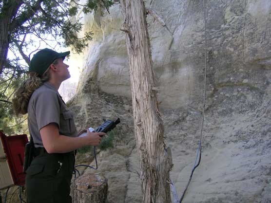 Image a of park ranger monitoring a crack in the rock