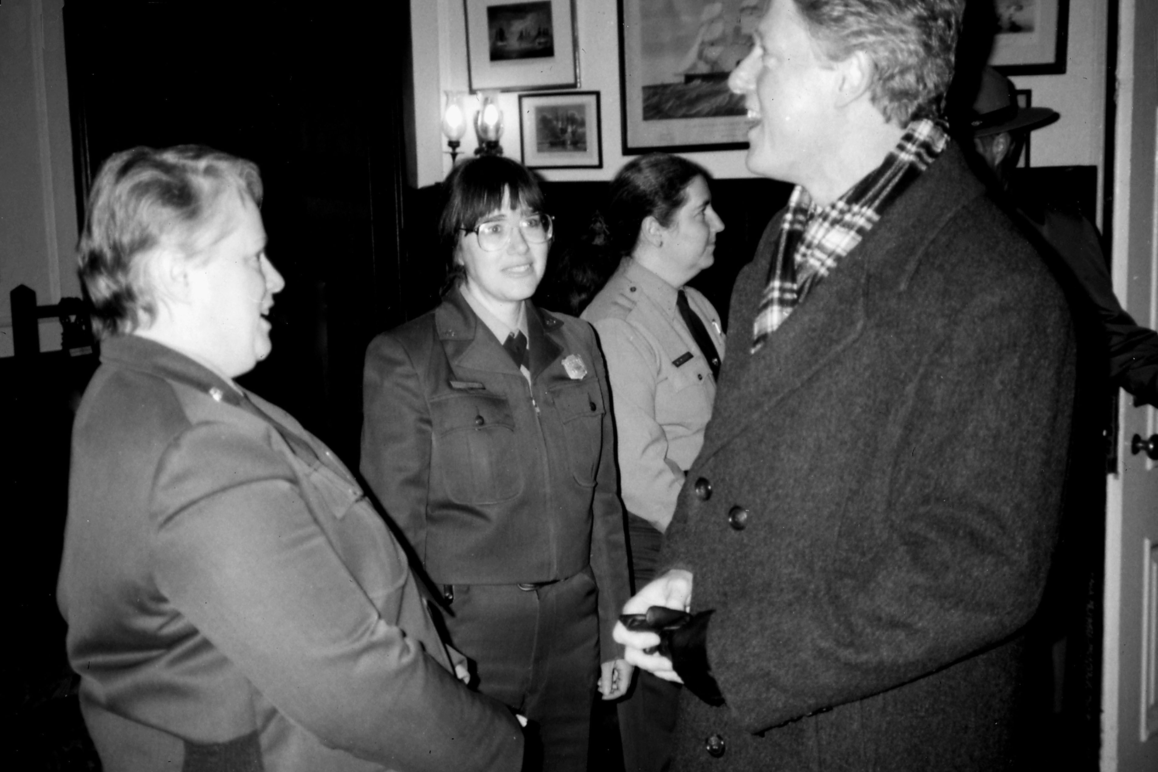 A group of people stands talking