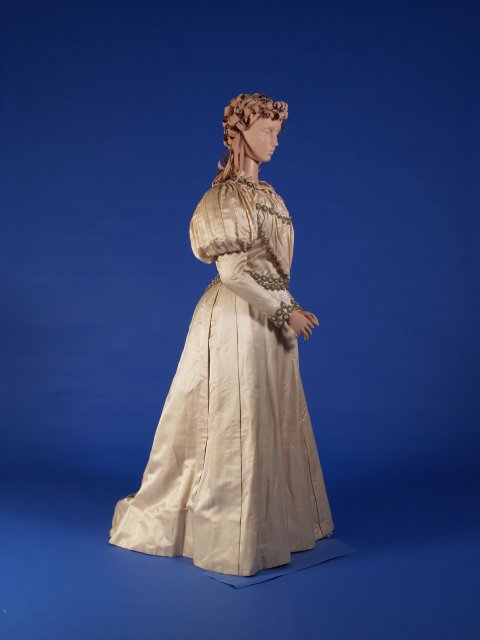 A cream-colored gown with puffy sleeves