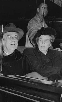 FDR and Eleanor Roosevelt seated together in an automobile A man and a woman seated in an automobile