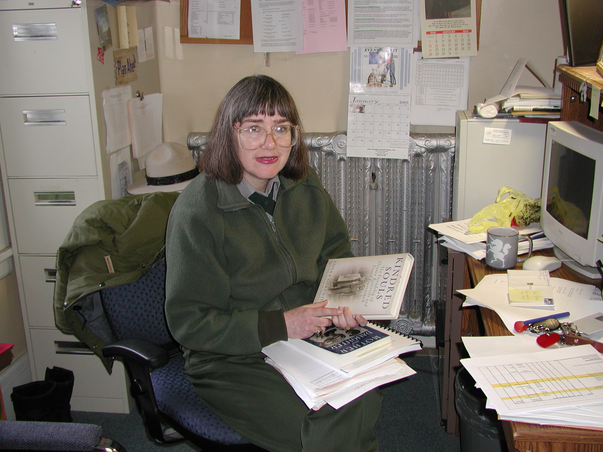 A woman sits at a desk