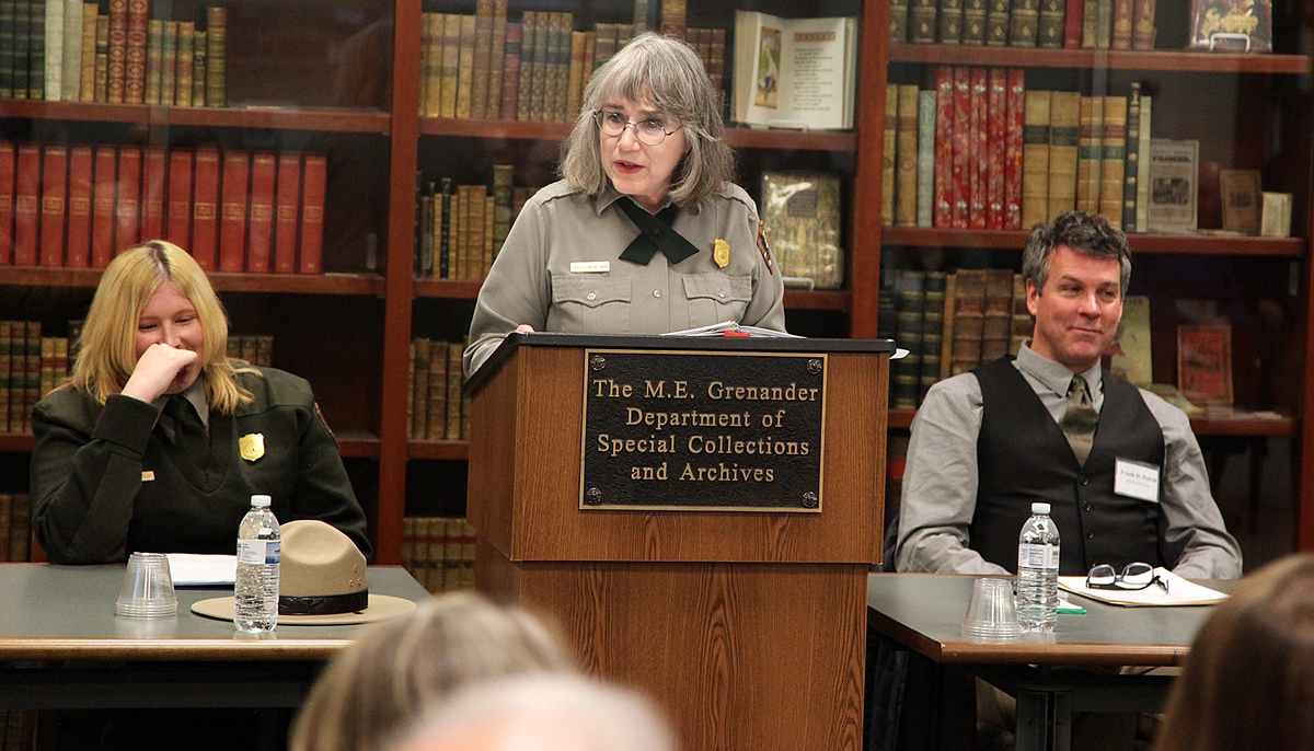 A woman gives a speech at a podium