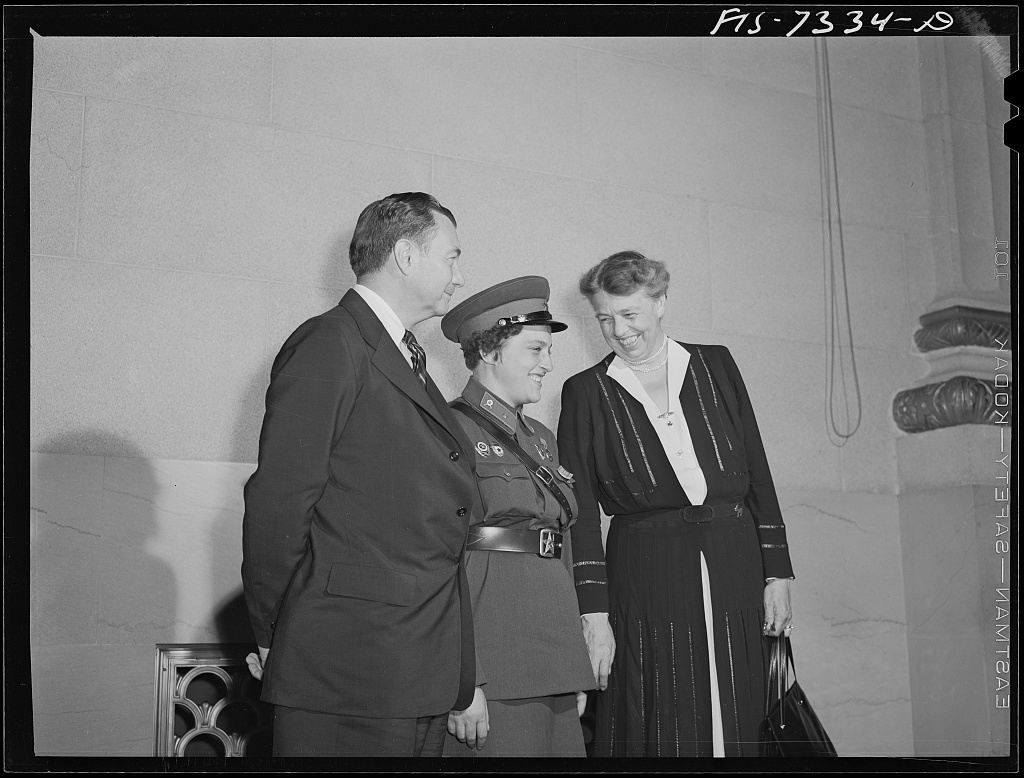 Justice Robert Jackson, Lyudmila Pavlichenko, and Eleanor Roosevelt A man in a suit stands next to a young woman in an army uniform and an older woman