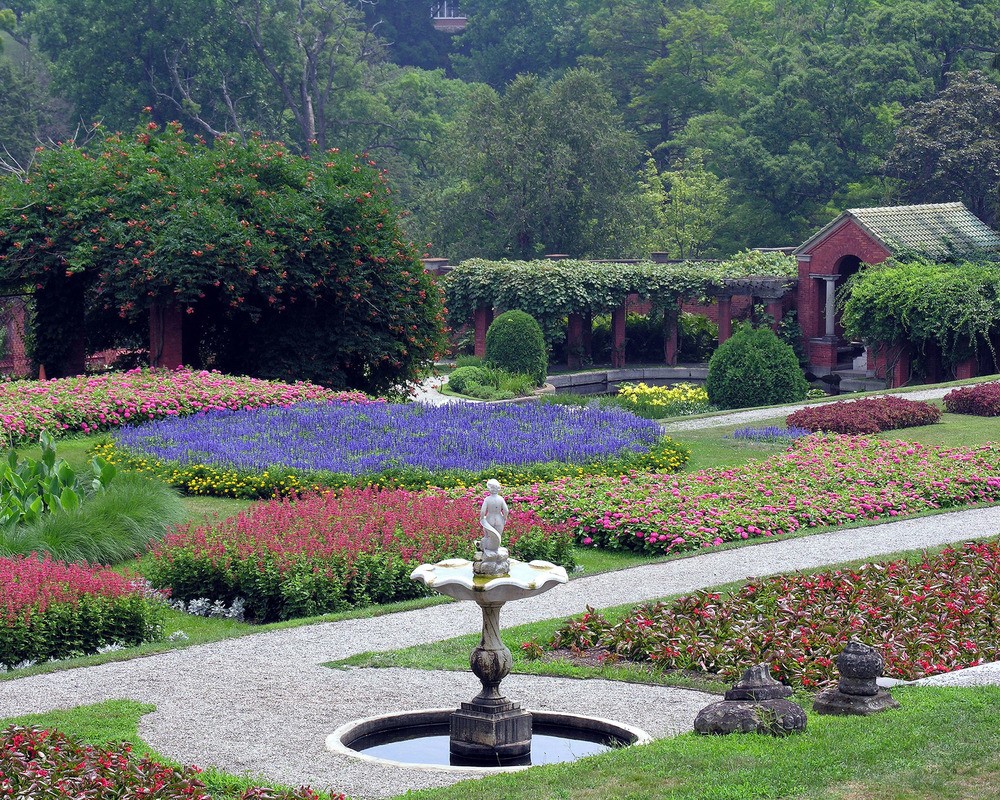 Red, pink, and purple flowers in a terraced garden.