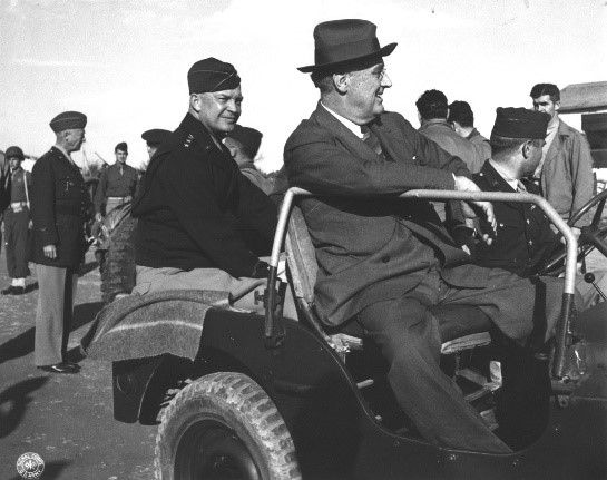 Two men ride in a Jeep.