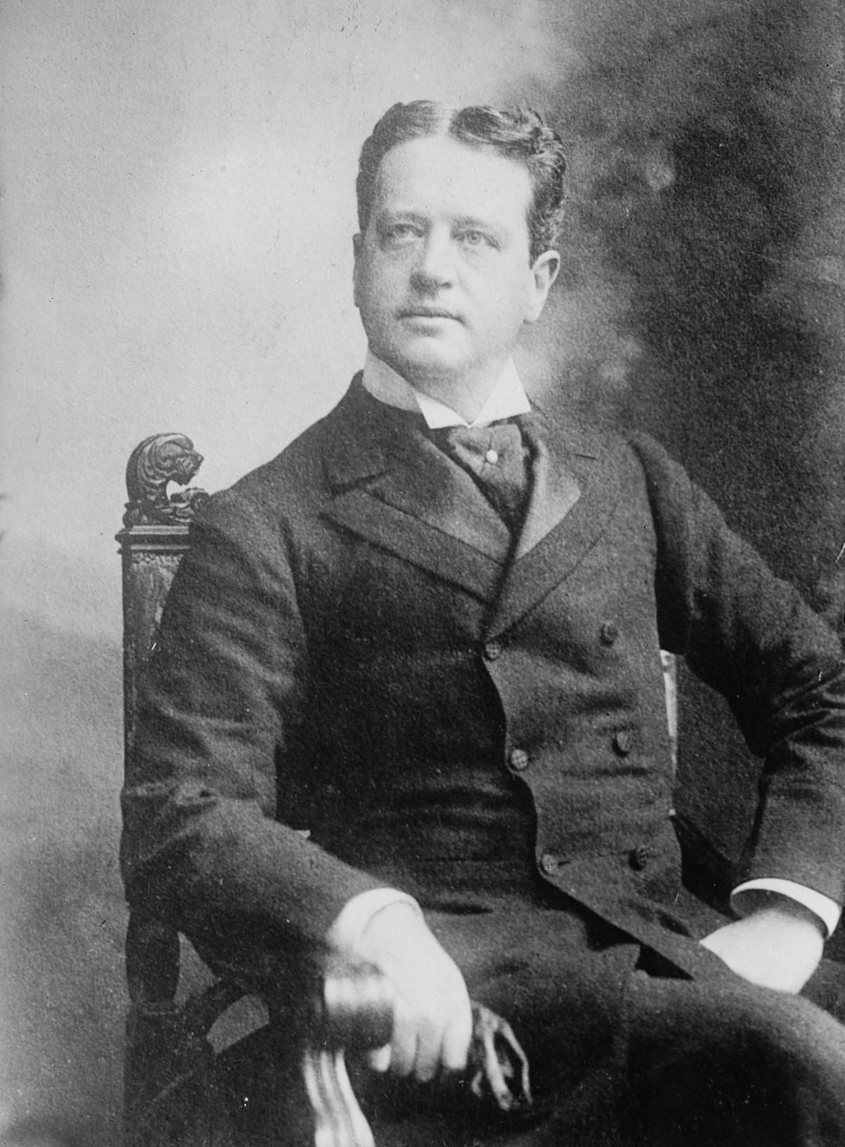 William Kissam Vanderbilt A man in a suit sits in a chair.