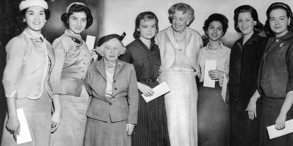 A group of women standing outdoors.