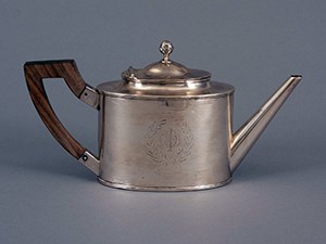 Silver tea pot with wood handle.
