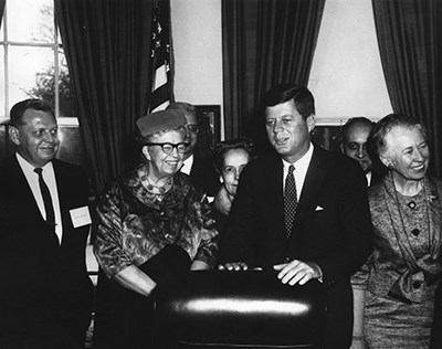 A group of people standing in an office.