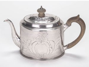 A silver teapot with wood handle.