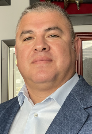 Gerardo González face and shoulders of man with very short graying hair