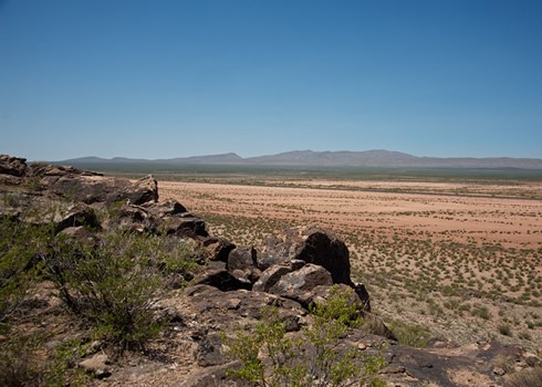 landscape of rocks with mountains in the back