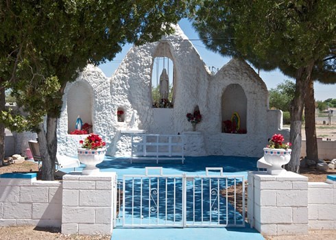 a shrine with flowers and three virgin Mary