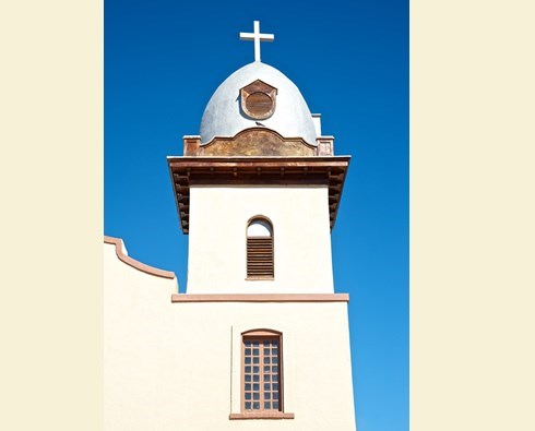 image of tower of a white church with a cross