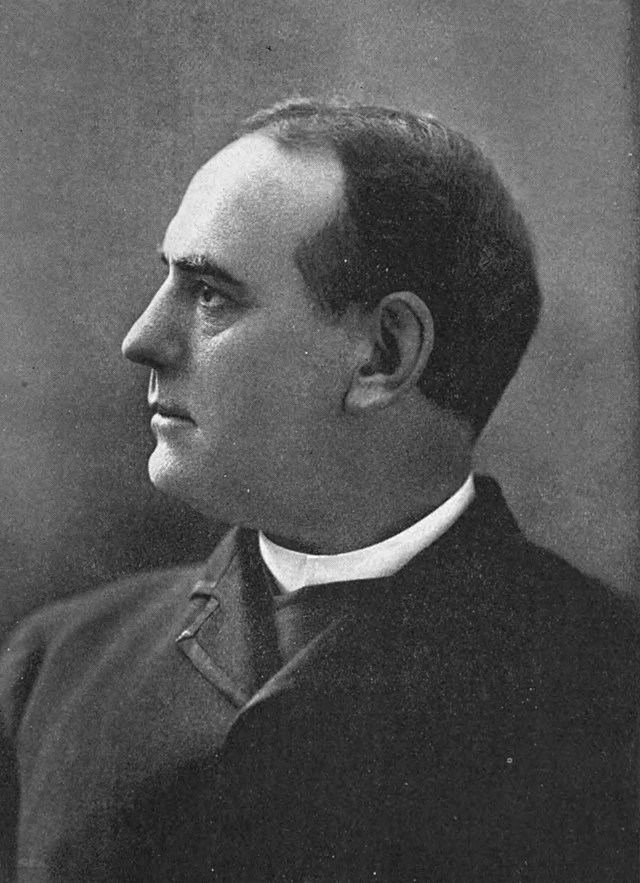 A portrait of a distinguished man in a suit. He has short dark hair. The portrait is a side profile.