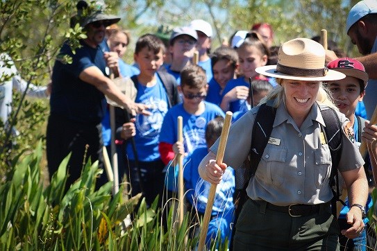 ranger with students following behind her
