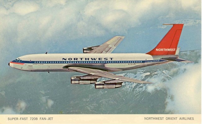 Postcard image of Northwest plane flying over mountains and through clouds. Text reads Super-fast 720B Fan-Jet, Northwest Orient Airlines