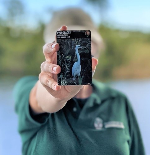 Rachel DiPietro holds the 2021 Everglades National Park annual pass to the camera.