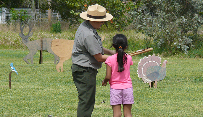 A girl plays with a bow and arrow during Calusa Day.