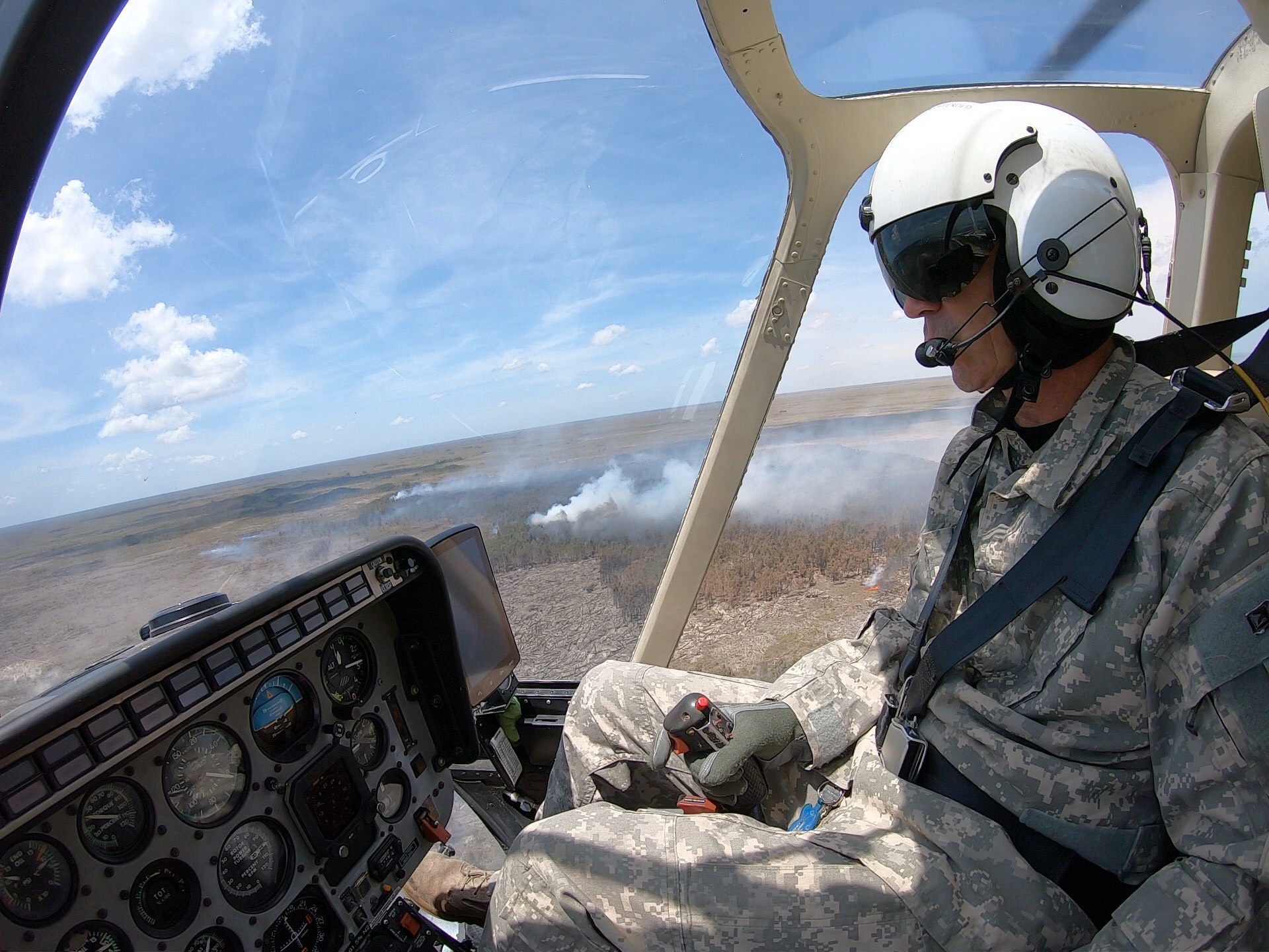 Helicopter pilot over Sunday Afternoon Fire in Everglades National Park Helicopter pilot in the air with view of smoke from the landscape below