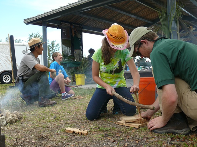 Ranger and volunteer teach historic fire making skills