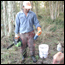 Field technician with chainsaw and squirt bottle