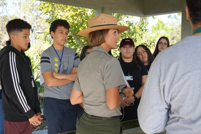 A park ranger talking to a group of students