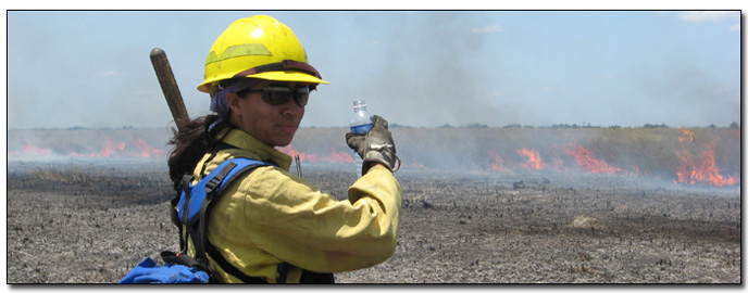 Firefighter Stands before Active Wildfire Firefighter Stands before Active Wildfire