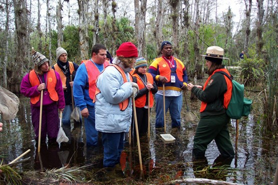 Ranger and visitors on a wet hike in a Cypress Dome