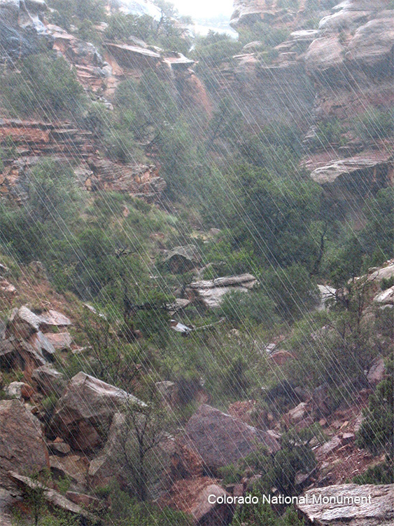Example of Precipitation - Image of rain falling on a rocky cliff
