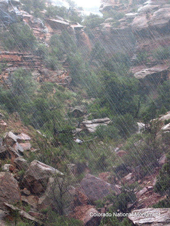 Example of Precipitation - Image of rain falling on a rocky cliff
