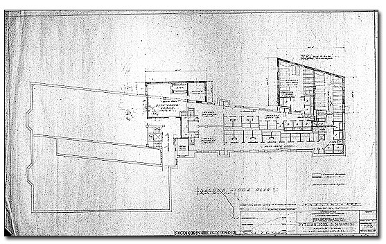 Black on white architectural drawing of the second floor of the Pythian. It is an odd-shaped floor plan. On the left end is a rectangular-shaped wing. Adjoining the upper right of that is a long hallway and at the right end of this hallway, there is another wing protruding to the rear. The long hallway is the bath hall with bath stalls shown. 