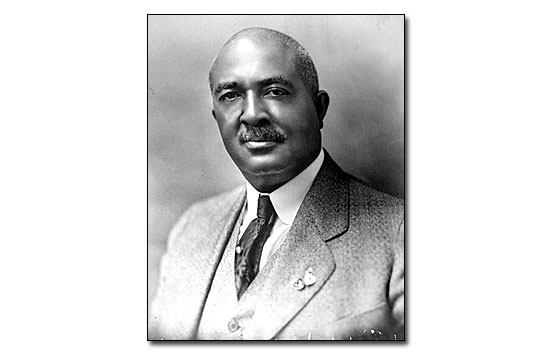 Black and white portrait of John Webb in a tweed business suit with white shirt and tie. Mr. Webb's hair is trimmed very short and he has a mustache.