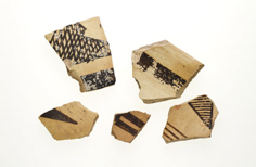 Five pieces of pottery with patterns on them.