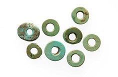 Eight pieces of turquoise with holes in them.