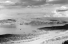 View of a lake with mountains in the background.