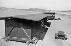 Small buildings with picnic tables in front.