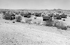 Many small cabins in desert.