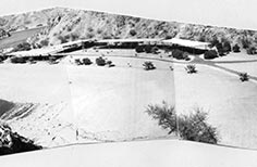 Combination of three photos to create a panoramic of a campground next to water.