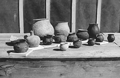 Pottery pots sitting on a table.