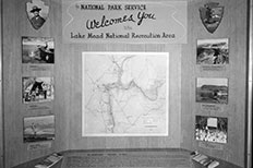 Welcome display for Lake Mead National Recreation Area with a map drawing in the center surrounded by pictures of people and landscape. 