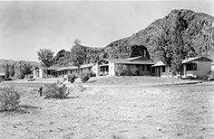 Large building up against a mountain.