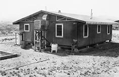 Small structure with sloped roofing and windows.