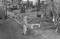 Man stands amongst construction site framework.