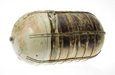 Aged rounded metal container.